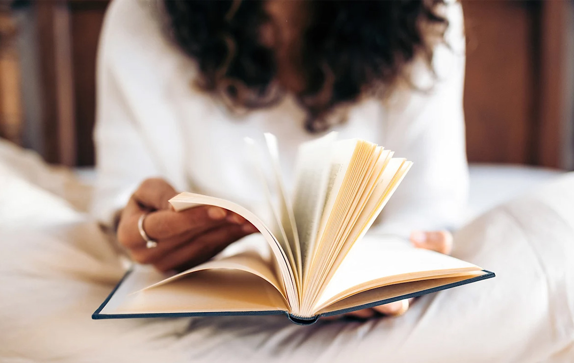 Woman turning the pages on a book