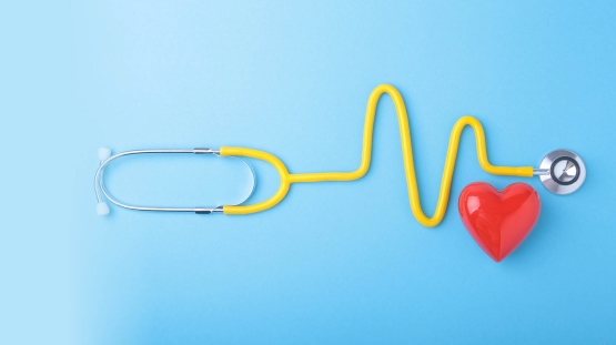 Heart and stethoscope on blue background