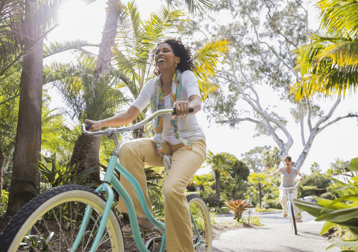 Woman smiling while riding bicycle at the park