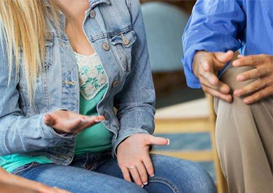 Patient sitting and speaking with therapist