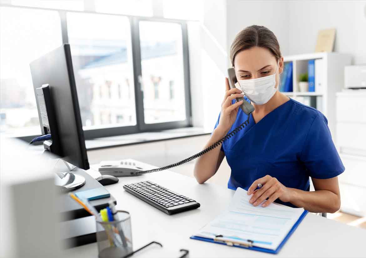 Nurse wearing mask while talking on the phone