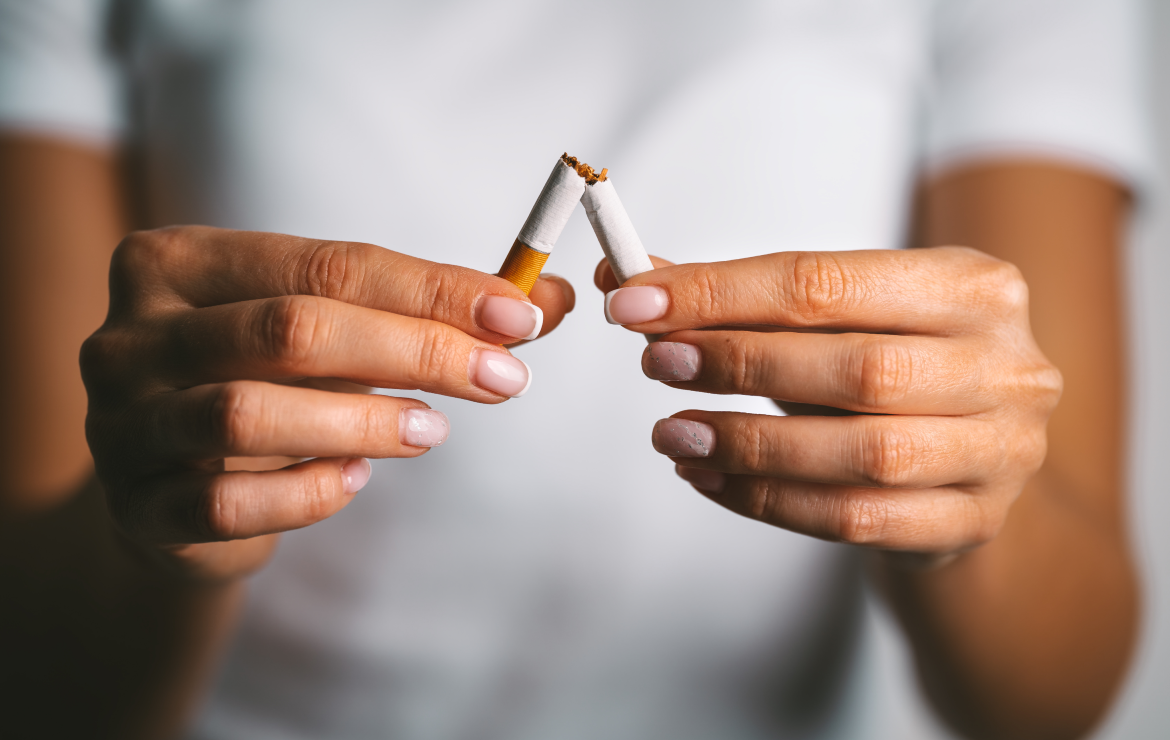 Woman breaking apart cigarette
