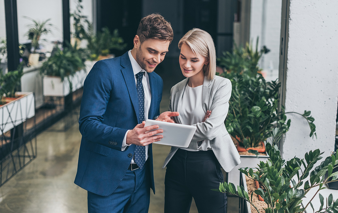 Business man and woman viewing tablet together