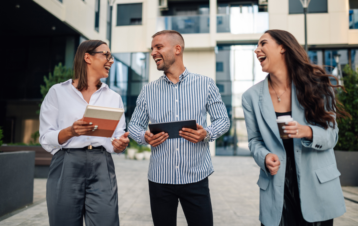 Businesspeople walking outside laughing together