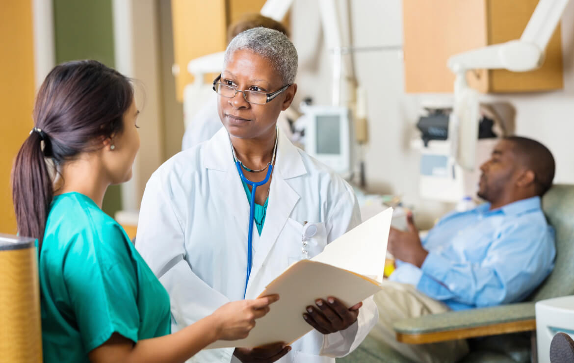 Doctor and nurse reviewing patient's record