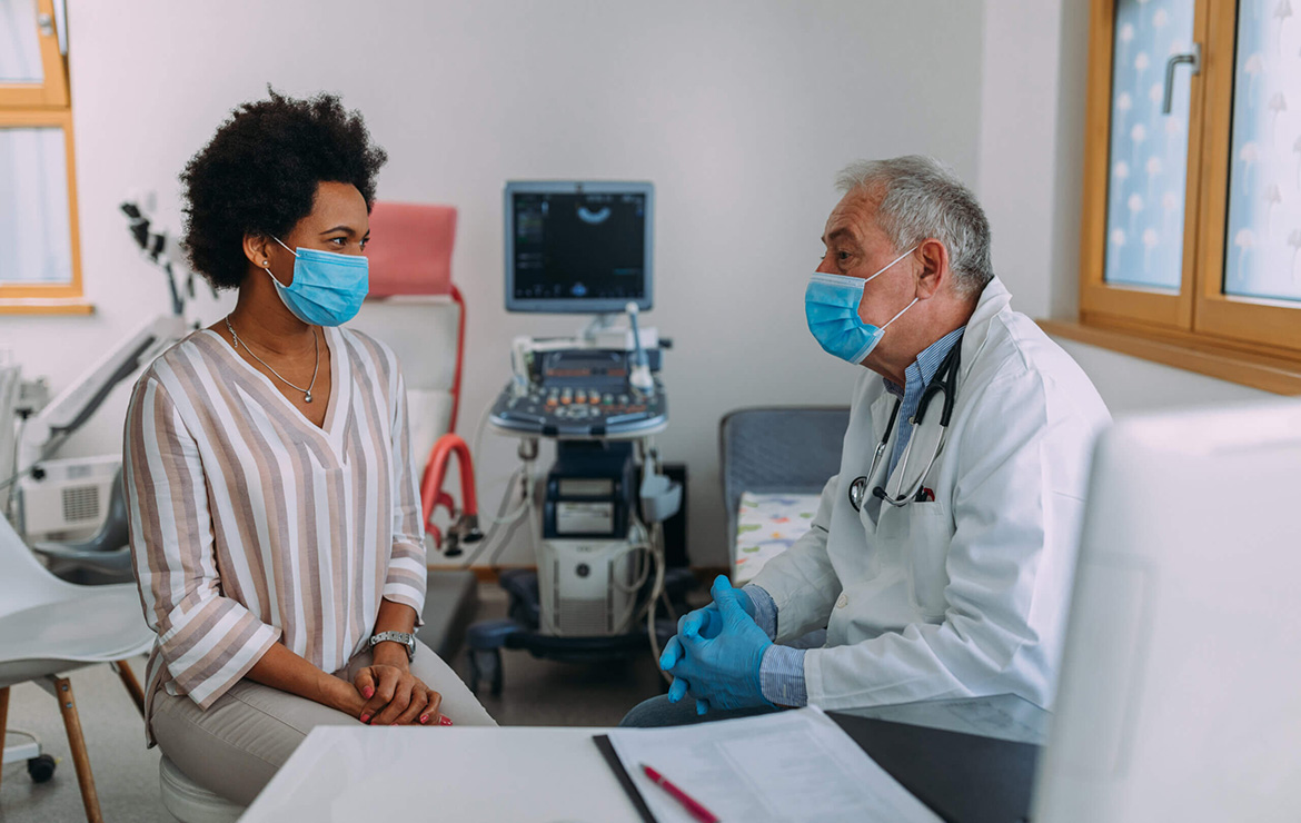 Doctor and patient talking with face masks on