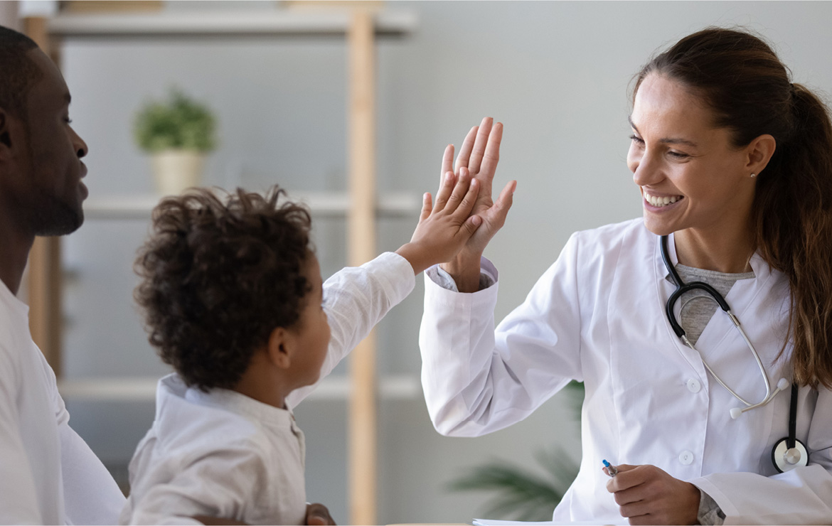 Doctor hi-fiving child