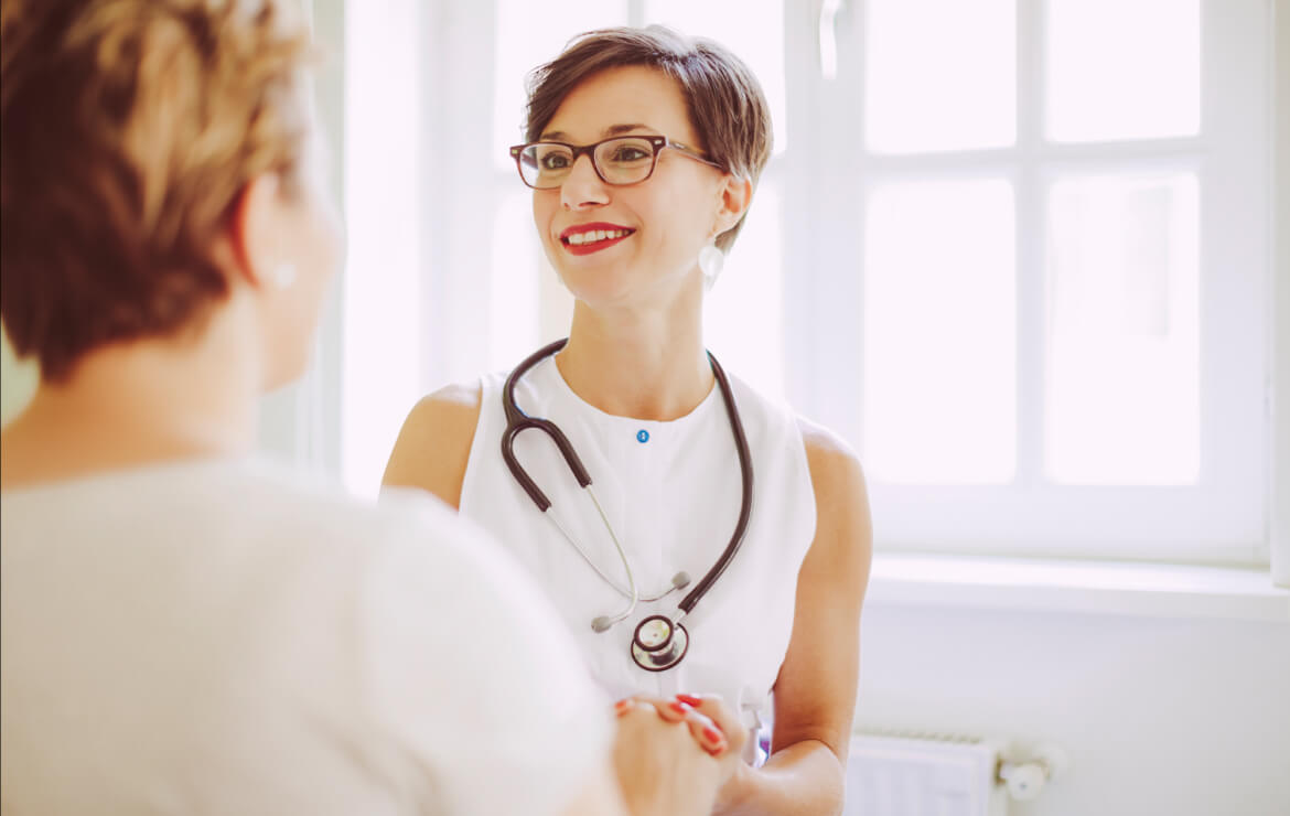Doctor wearing stethoscope talking with patient
