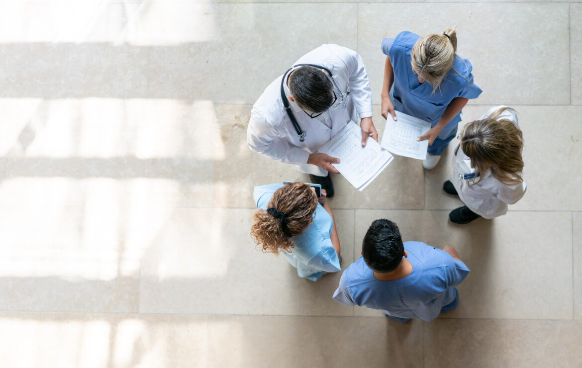 Doctors and nurses standing together in circle