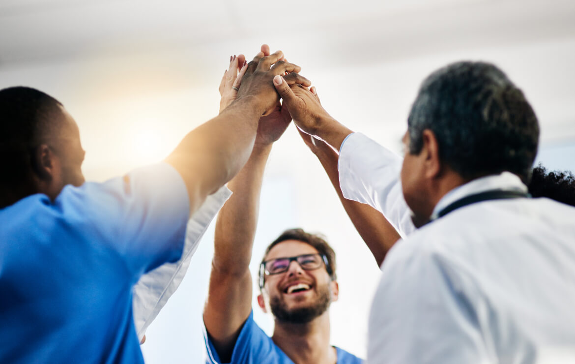 Doctors high fiving each other