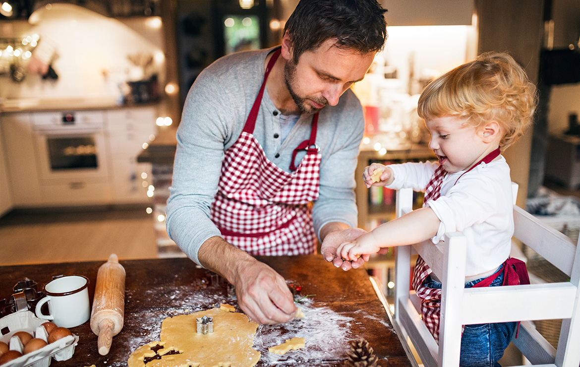 Father and son making gingerbread cookies