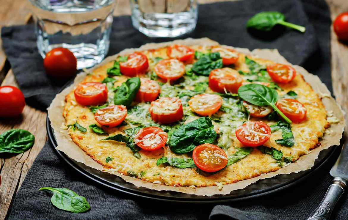 Full margherita pizza on silver platter