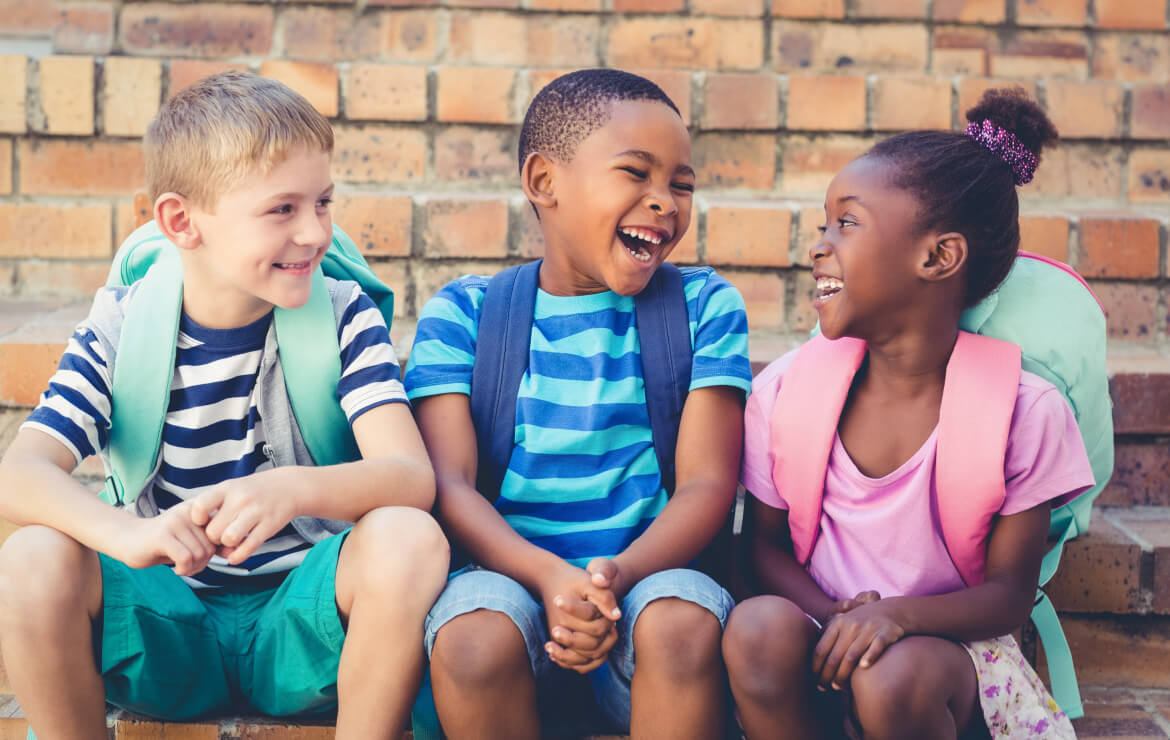 Group of children sitting together laughing