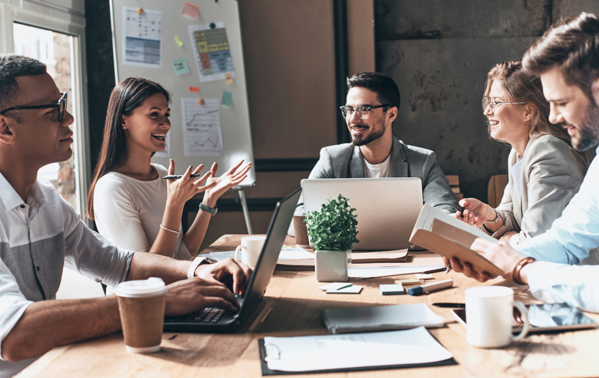 Group of young adults working together in office