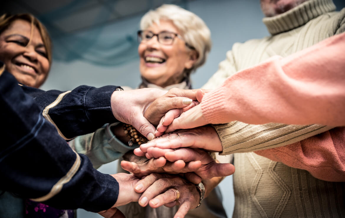 Group of women putting hands together
