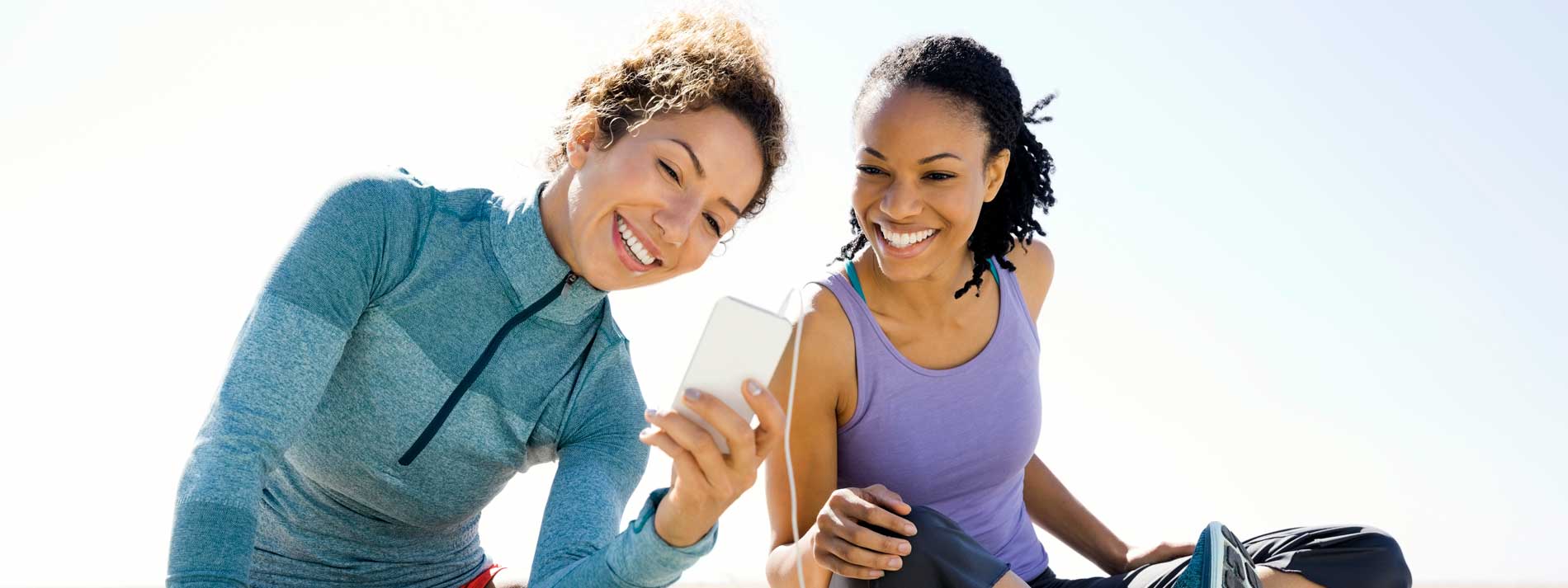Two friends viewing mobile phone device