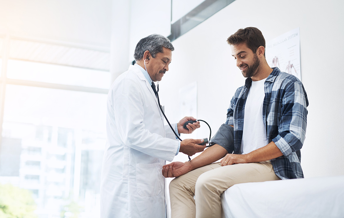 Man getting blood pressure checked by doctor