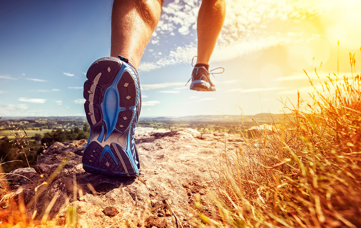 Man jogging on mountain terrain