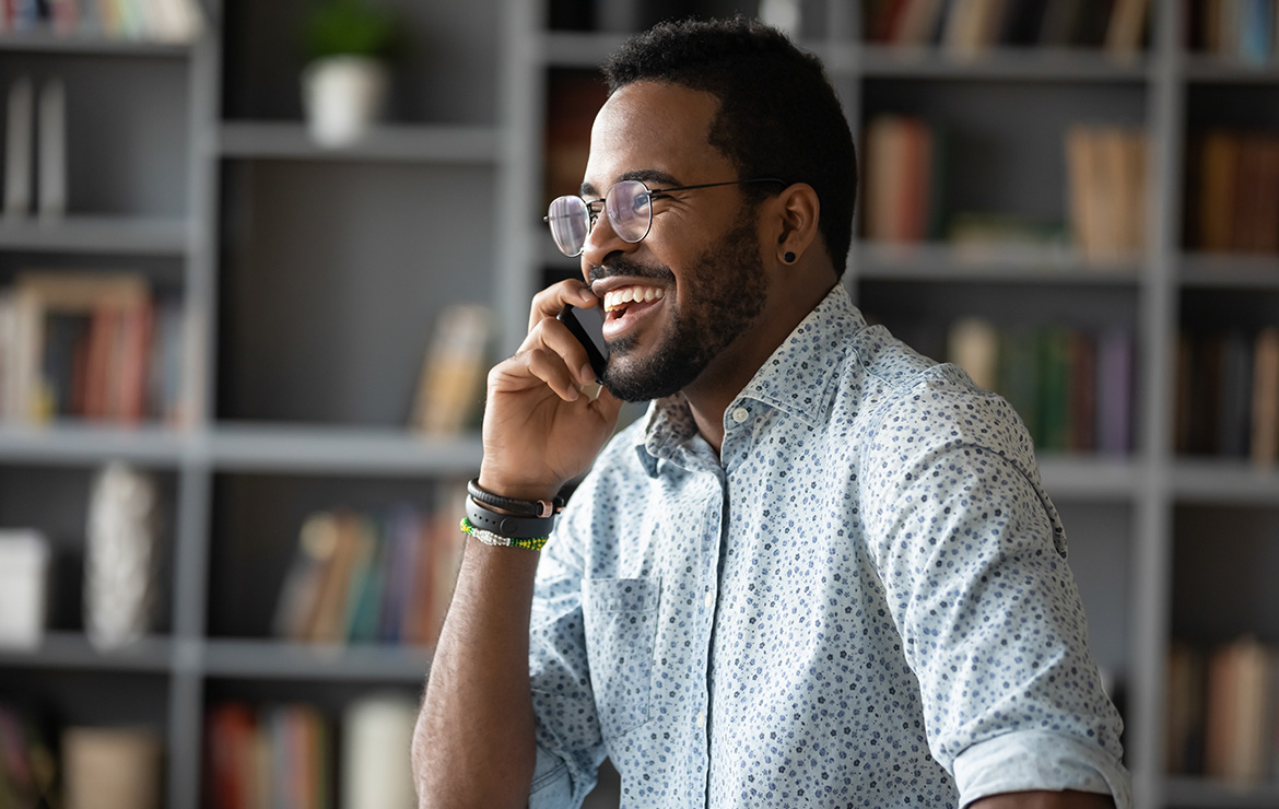 Man laughing while on the phone