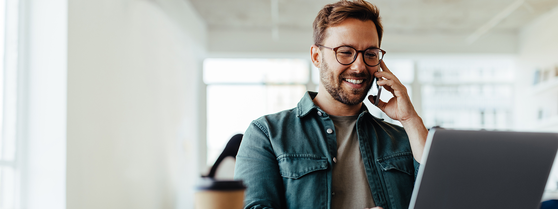 man-using-phone-and-laptop-hero@1900x713