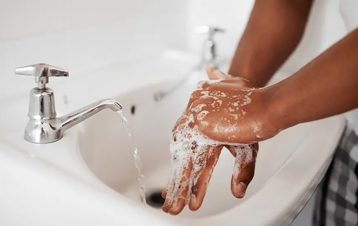 Person washing hands with soap
