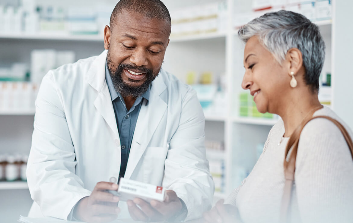 Pharmacist prescribing medicine to patient