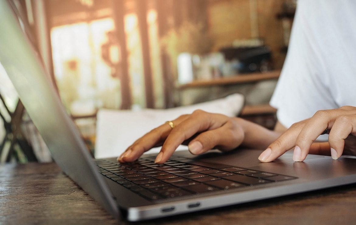 Photo of hands using laptop