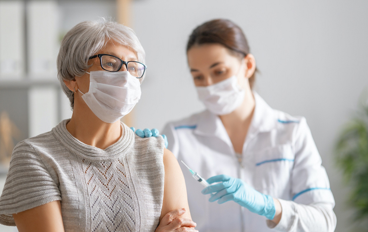 Senior woman getting vaccinated in arm