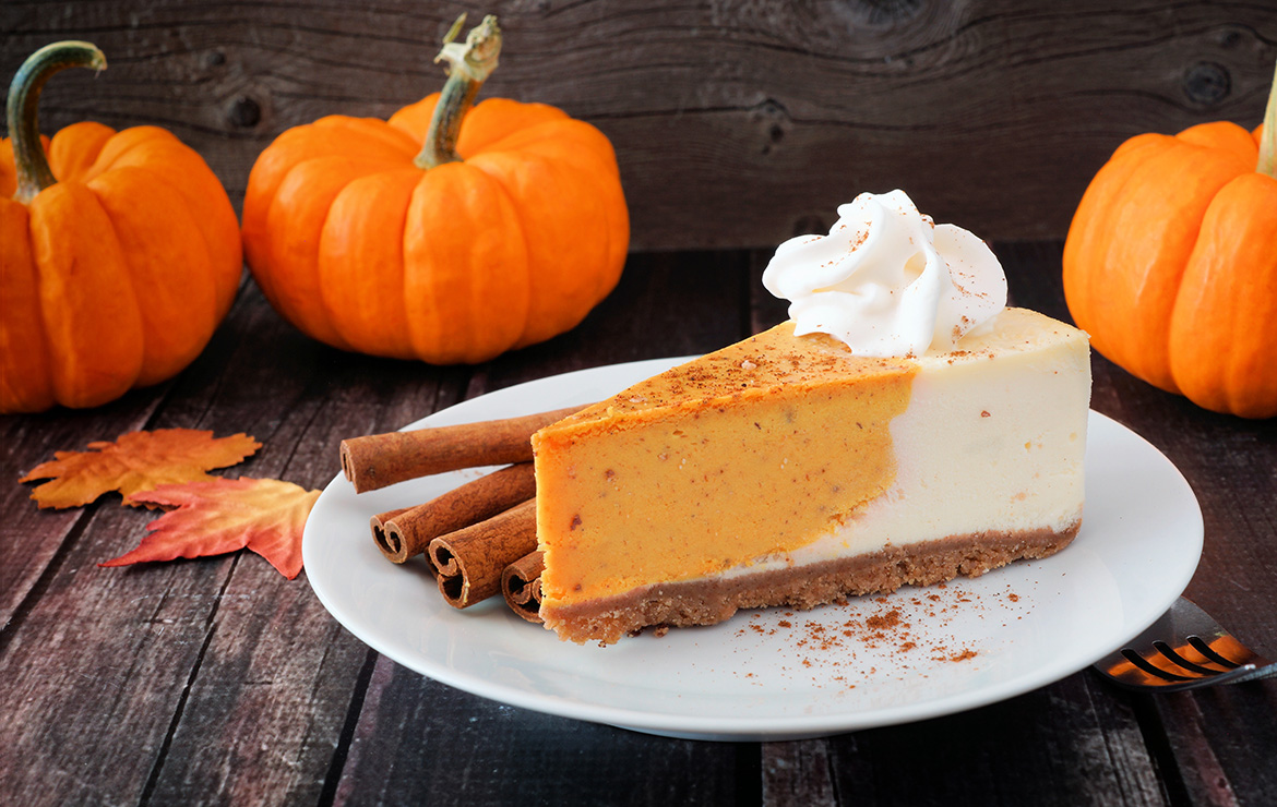 Slice of pumpkin cheesecake with whipped cream