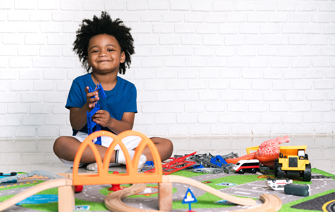 Smiling child playing with toys