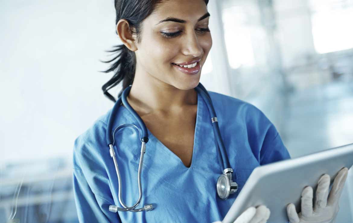 Smiling woman doctor using tablet