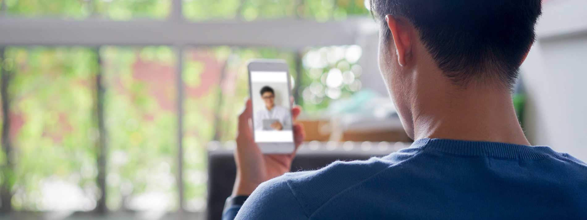 Man receiving video telehealth call on mobile phone
