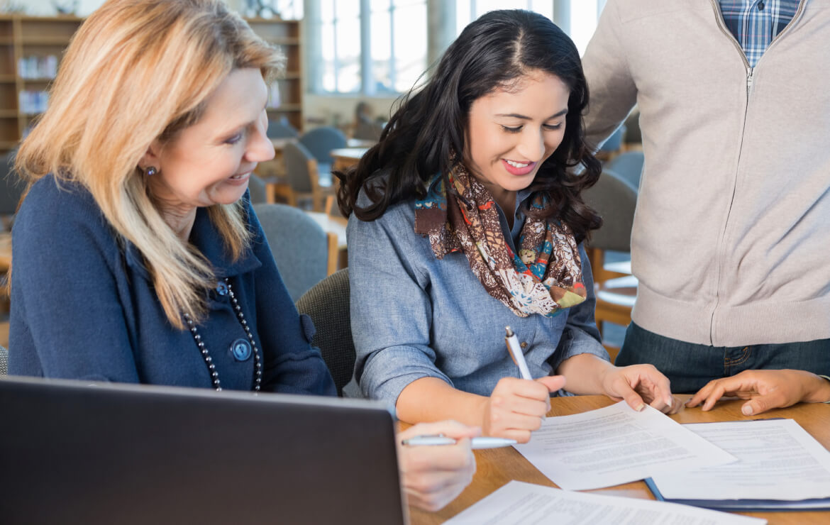 Woman assisting member with paperwork
