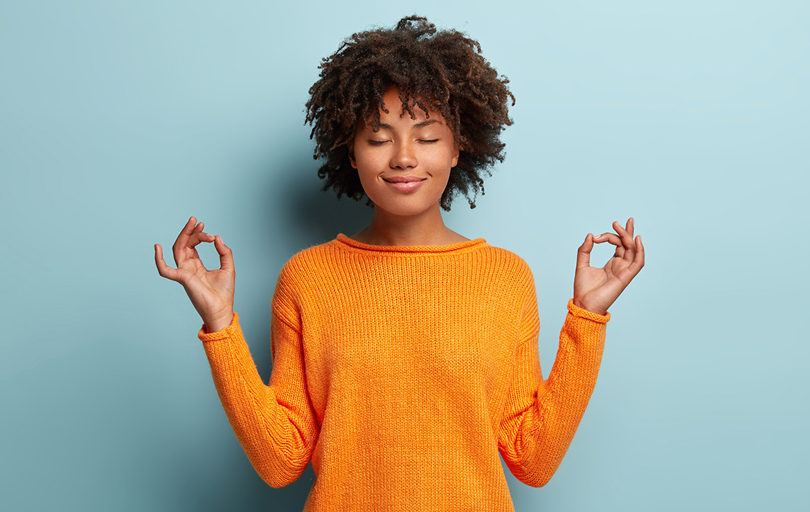 Woman closing eyes touching fingertips