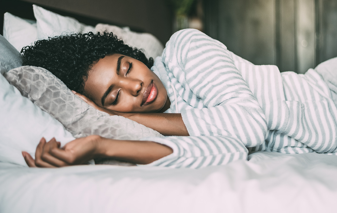 Woman laying down in bed sleeping