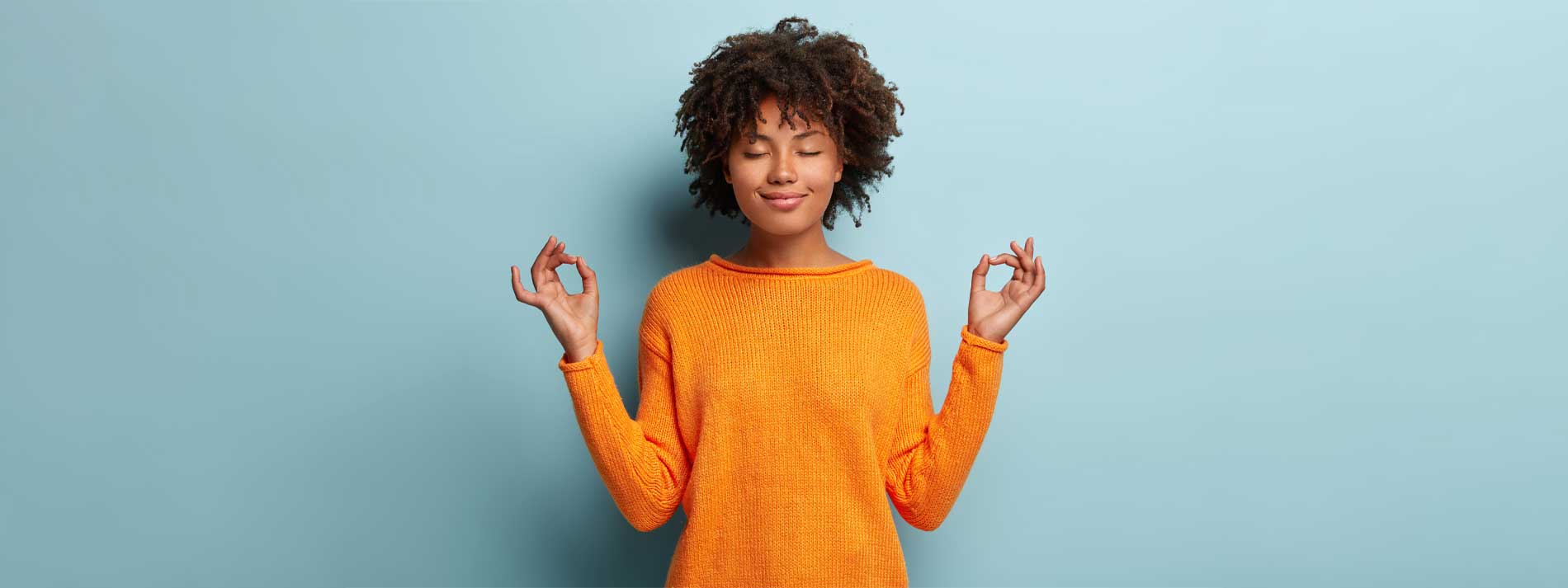 Woman standing and holding mindful pose