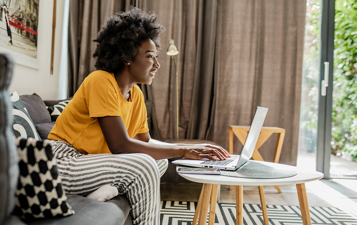 Woman sitting down using laptop