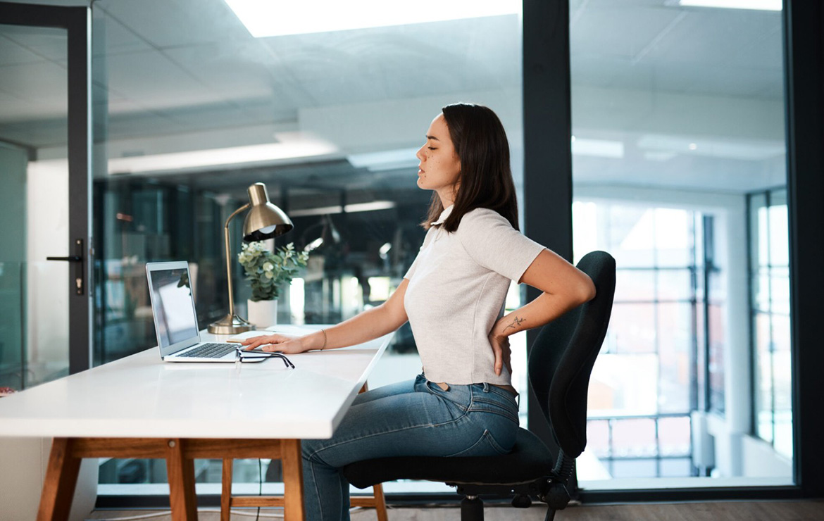 Woman sitting on chair touching back