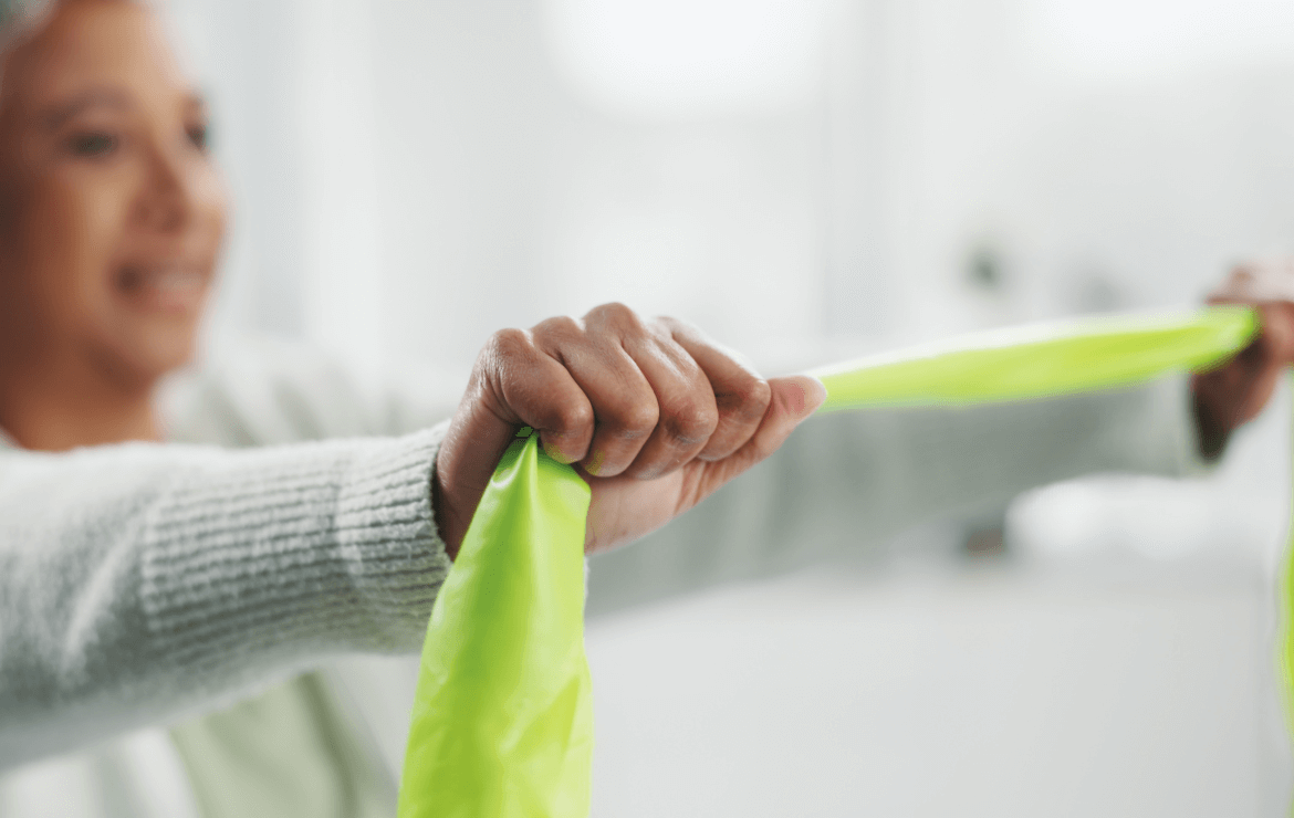 Woman stretching arms using a resistance band