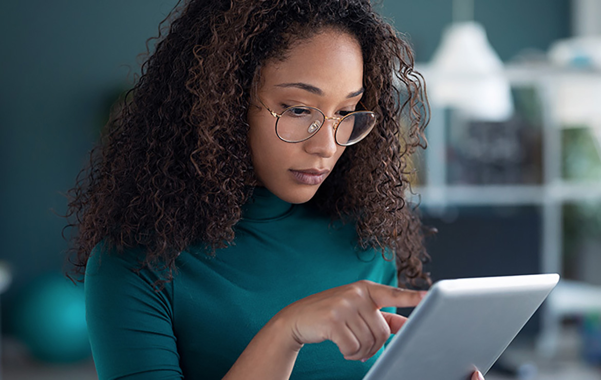 Woman tapping on tablet