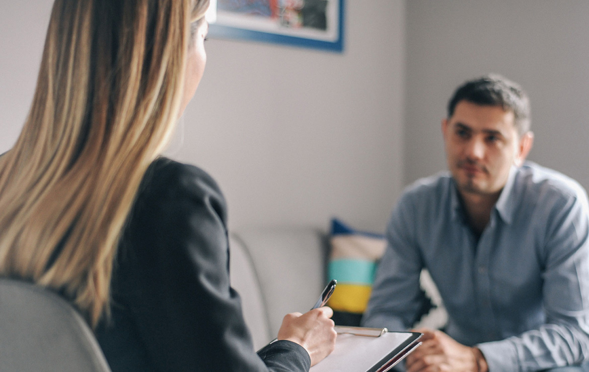 Woman therapist listening to male patient