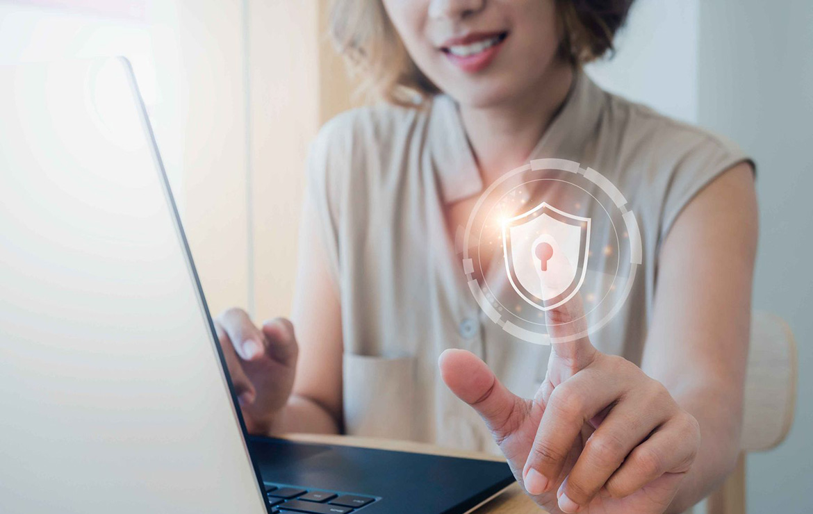 Woman using laptop and touching digital privacy lock image