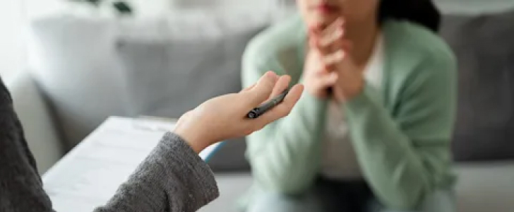 Therapist talking to patient on the couch