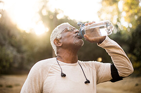 man drinking water after workout