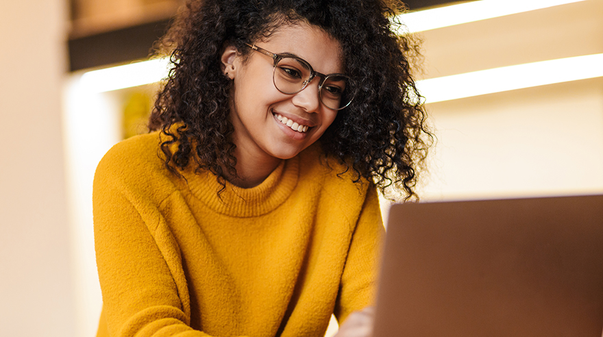 Smiling woman using computer