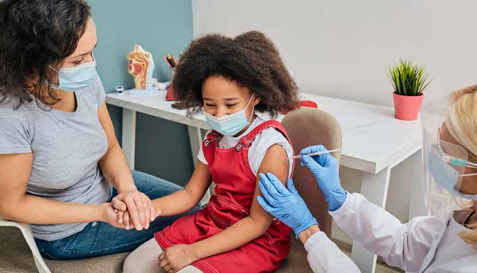 Mother and daughter receiving vaccine shot