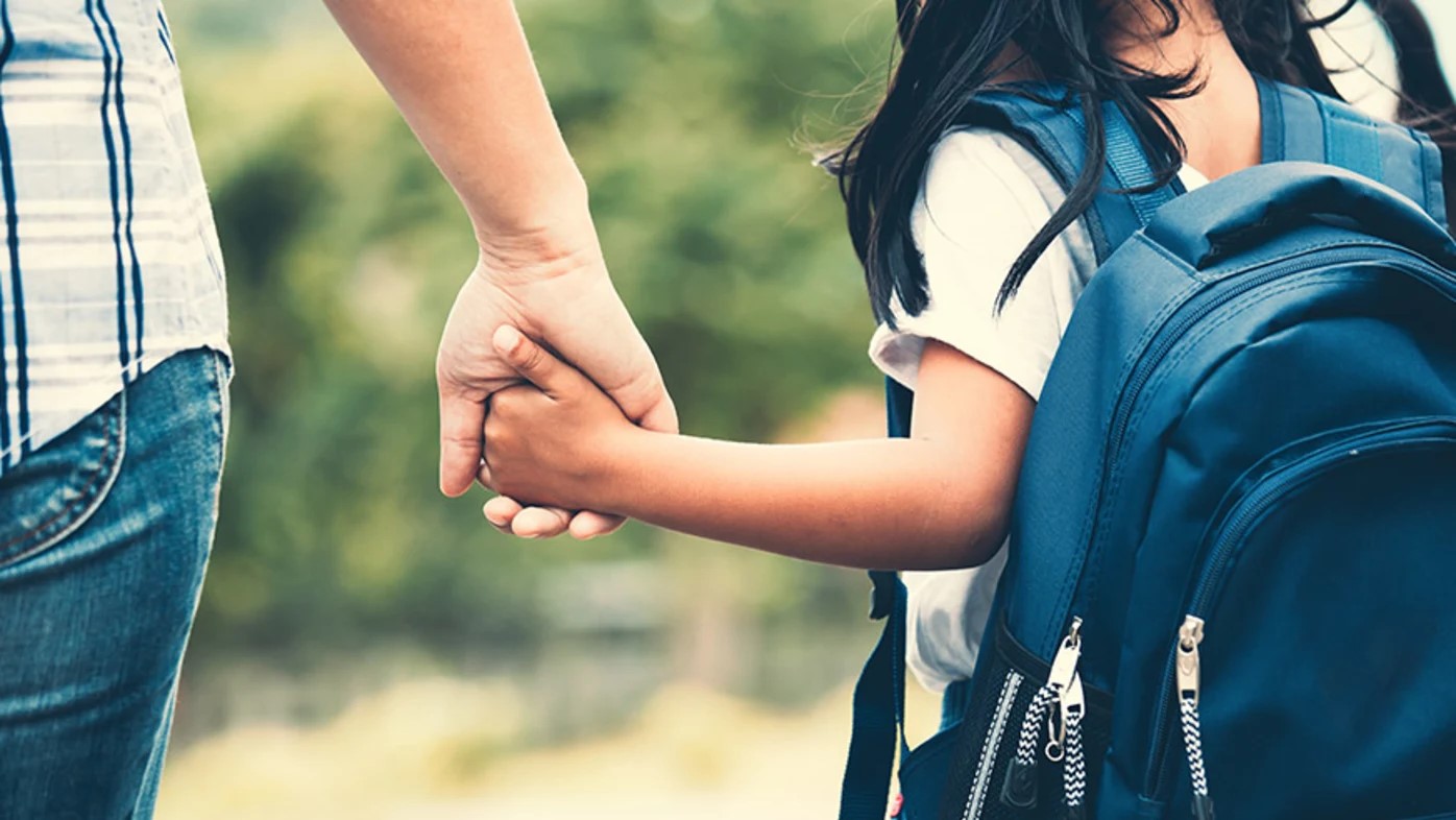 Parent holding child's hand