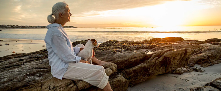 Senior woman at beach viewing sunset